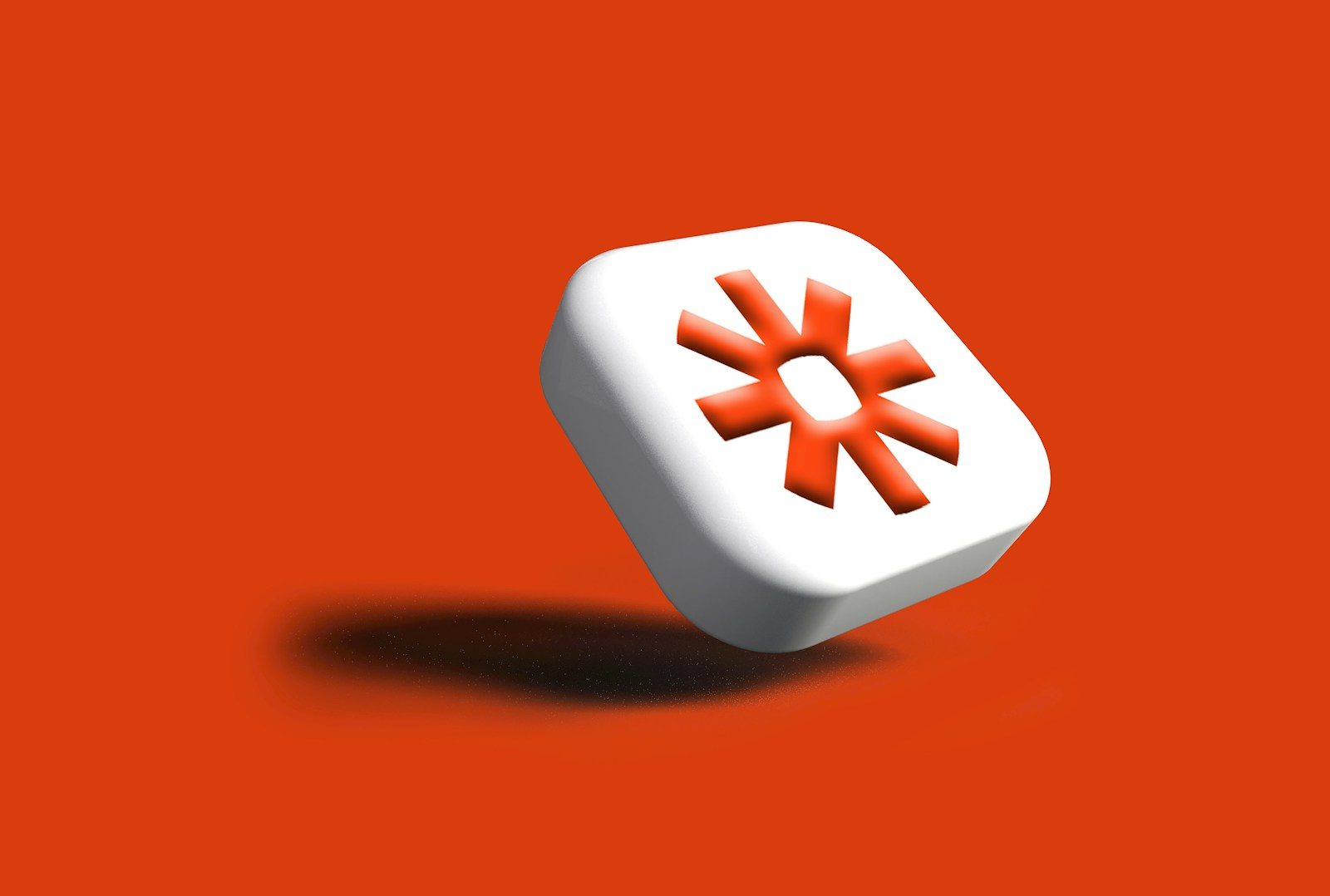 White cube with orange sun logo on red background
